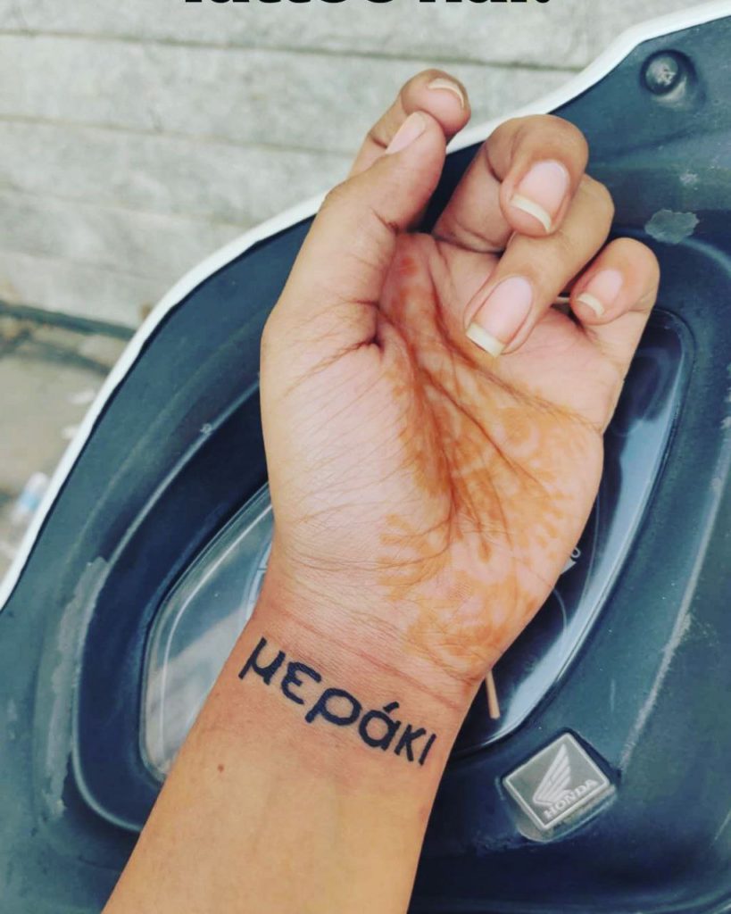 Meraki lettering tattoo on the wrist